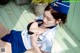 A woman in a blue and white uniform is posing for a picture.