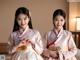 A couple of women in hanbok standing next to each other.