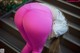 A woman in pink leggings bending over on some steps.